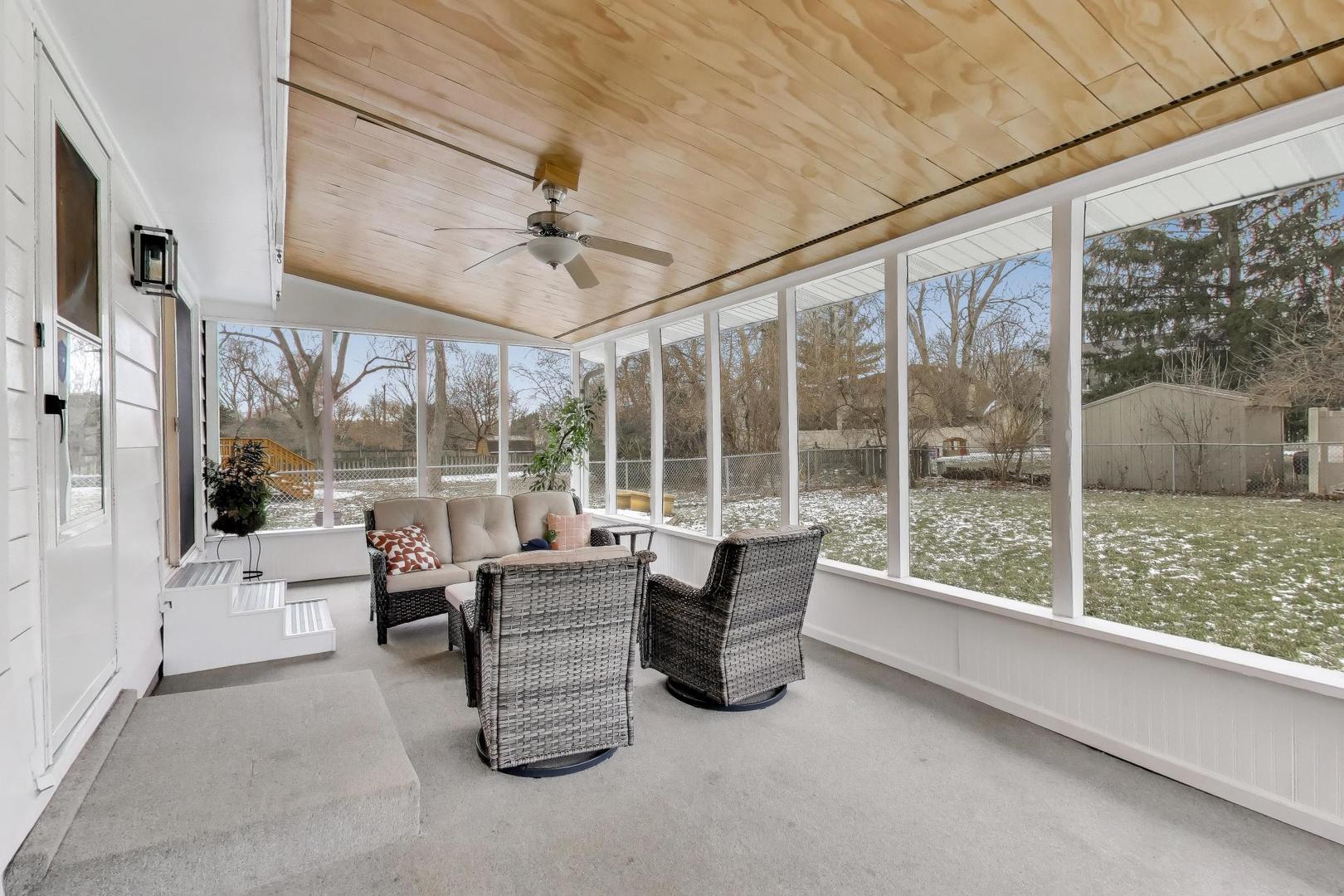 421 Berry Drive Naperville, IL 60540 - Photo 20 of 26 a living room with furniture and a floor to ceiling window