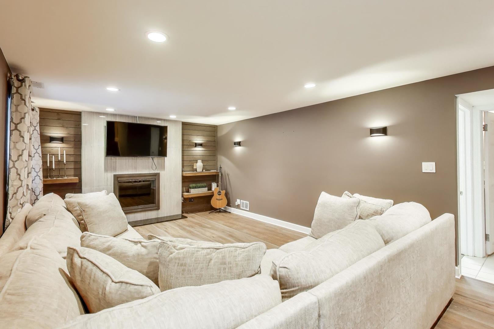 421 Berry Drive Naperville, IL 60540 - Photo 2 of 26 a living room with furniture and a fireplace
