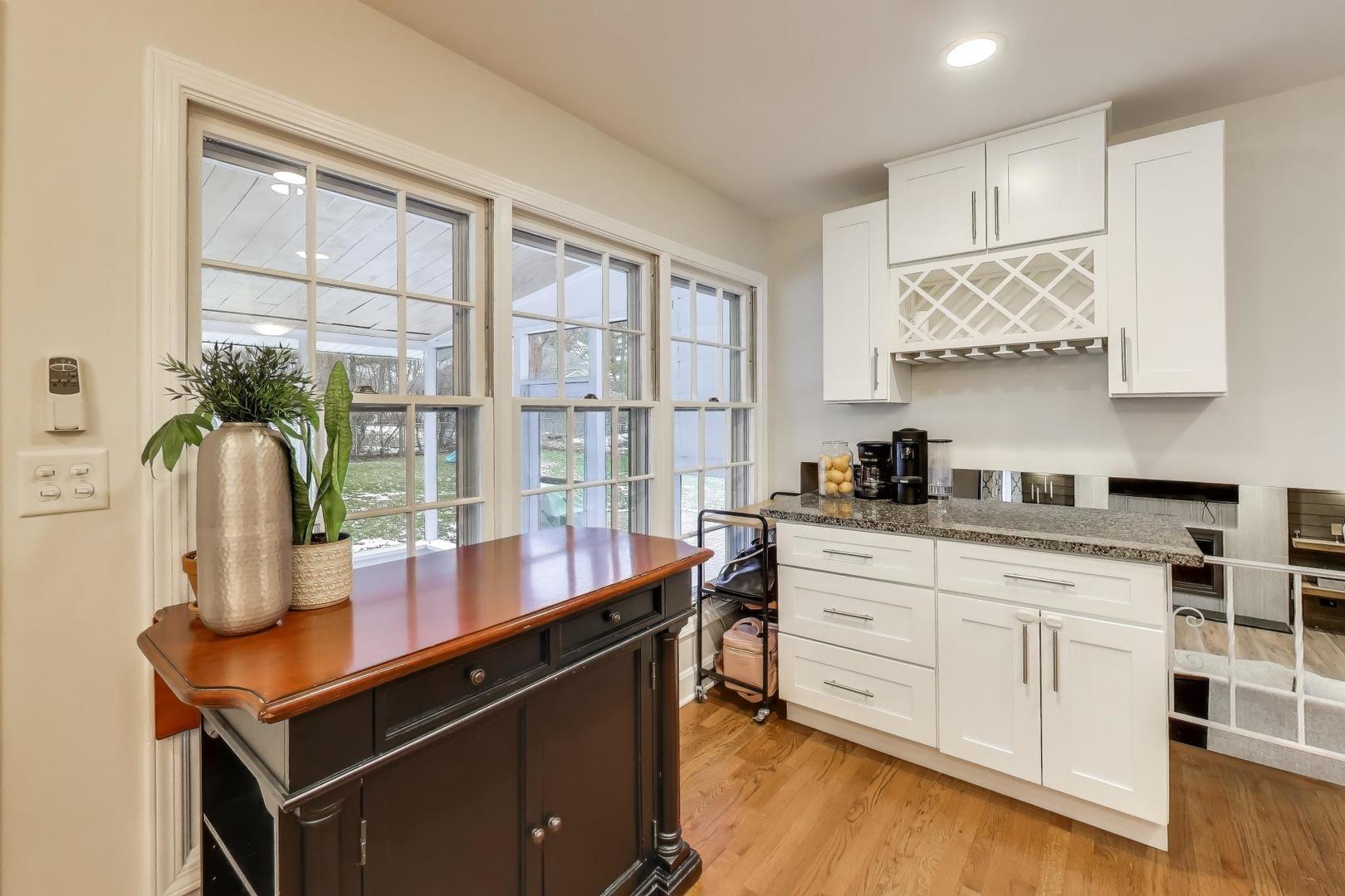 421 Berry Drive Naperville, IL 60540 - Photo 7 of 26 a kitchen with stainless steel appliances granite countertop a sink a stove and a wooden floors