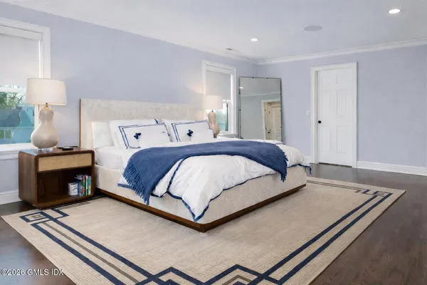 a bedroom with a bed and a night stand