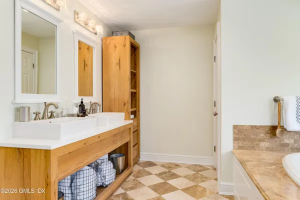 a bathroom with a sink double vanity and a mirror