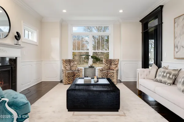 a living room with furniture a large window and a fireplace