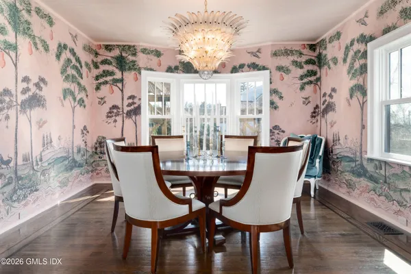 a view of a dining room with furniture wooden floor and chandelier
