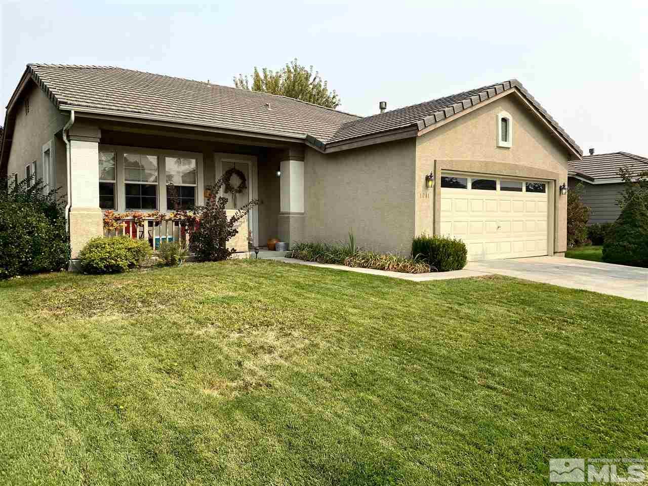 1641 Brentworth Way Reno, NV 89521 - Photo 1 of 11 a front view of a house with yard and porch