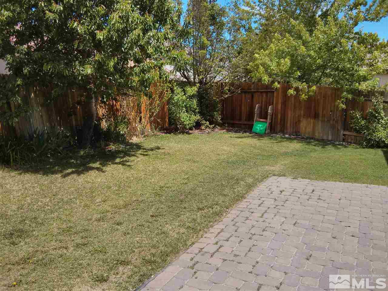 1641 Brentworth Way Reno, NV 89521 - Photo 8 of 11 a backyard of a house with a trees
