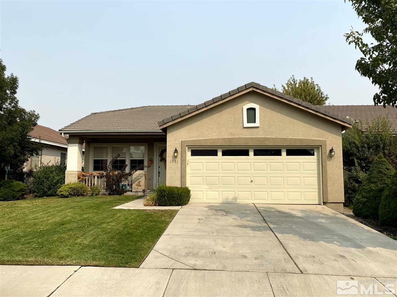1641 Brentworth Way Reno, NV 89521 - Photo 10 of 11 a front view of a house with a yard