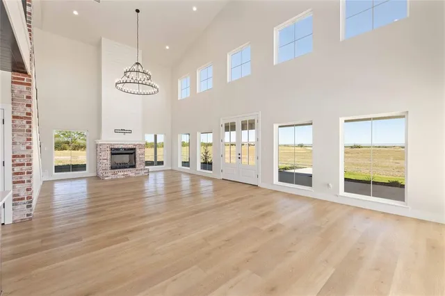 a view of empty room with kitchen view and window
