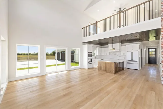 a view of a kitchen with furniture and wooden floor