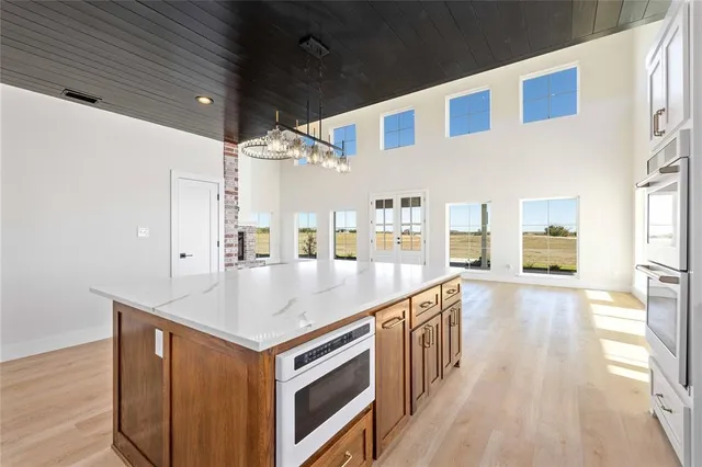 a kitchen with a stove and a wooden floor
