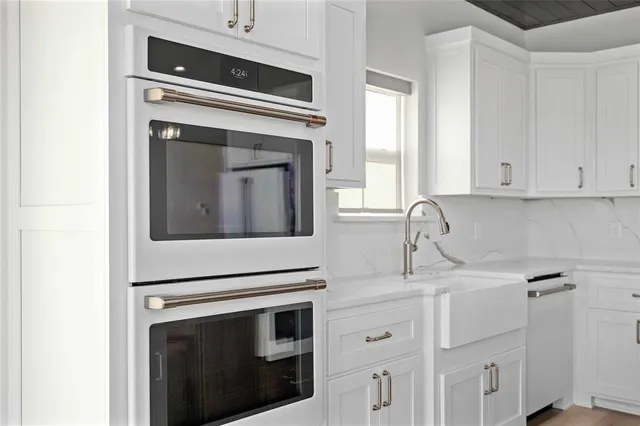 a kitchen with cabinets stainless steel appliances and a sink