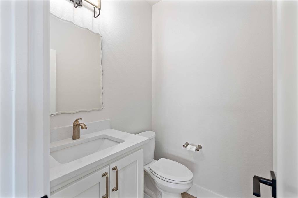 13808 Highway 206 Coleman, TX 76834 - Photo 25 of 40 a bathroom with a sink a toilet and a mirror