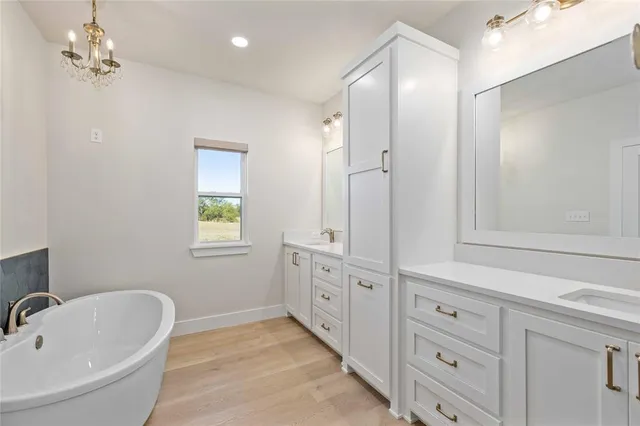 a bathroom with a tub sink and mirror