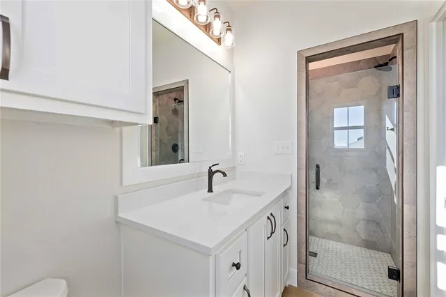 a bathroom with a sink a mirror and a shower