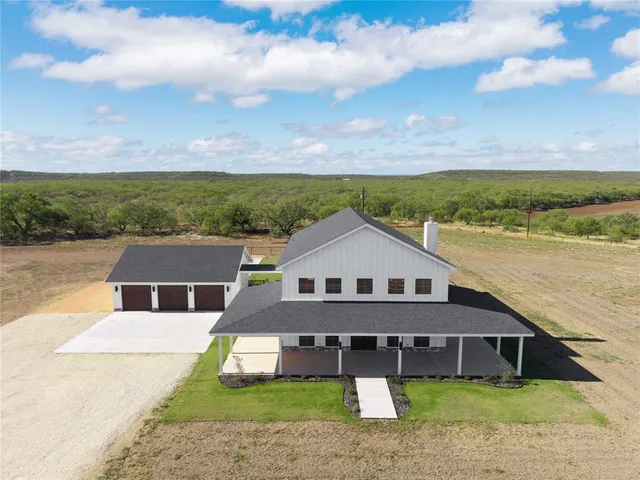aerial view of a house with a big yard