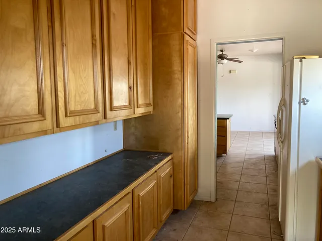 a kitchen with a refrigerator and cabinets