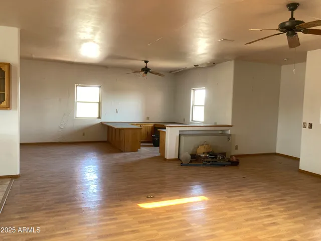 a view of an empty room with closet and a window