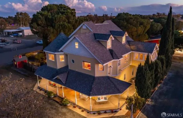 an aerial view of a house with a yard