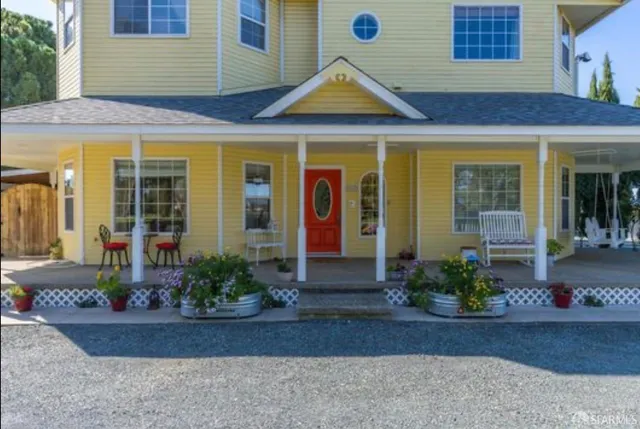 a kitchen with granite countertop stainless steel appliances a sink window and cabinets