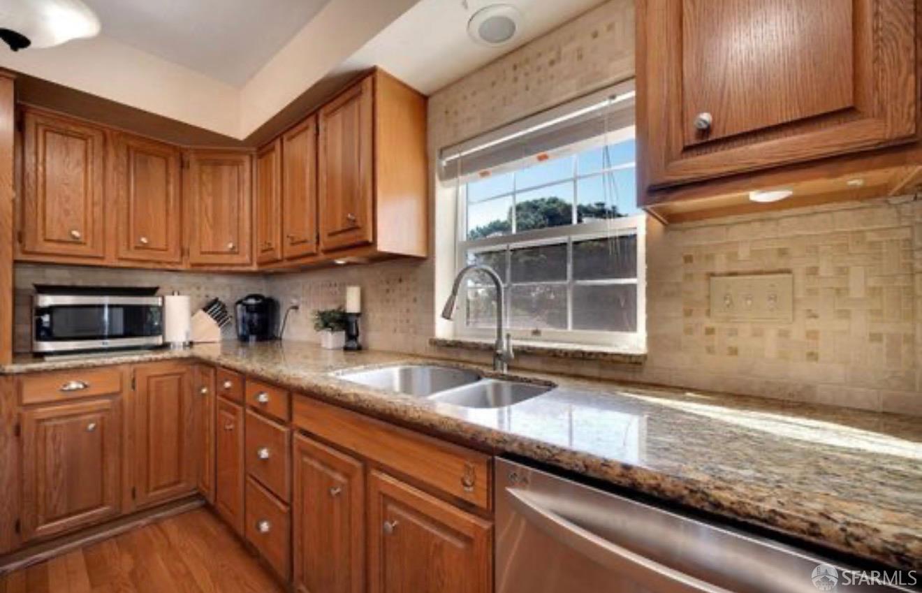 4100 Gateway Road Bethel Island, CA 94511 - Photo 14 of 53 a kitchen with granite countertop stainless steel appliances a sink window and cabinets