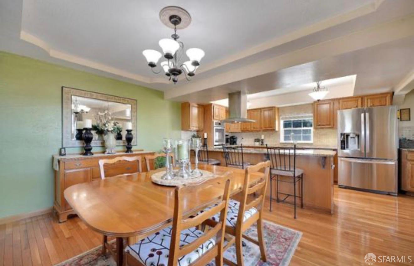 4100 Gateway Road Bethel Island, CA 94511 - Photo 19 of 53 a dining room with stainless steel appliances kitchen island granite countertop a table chairs and a chandelier