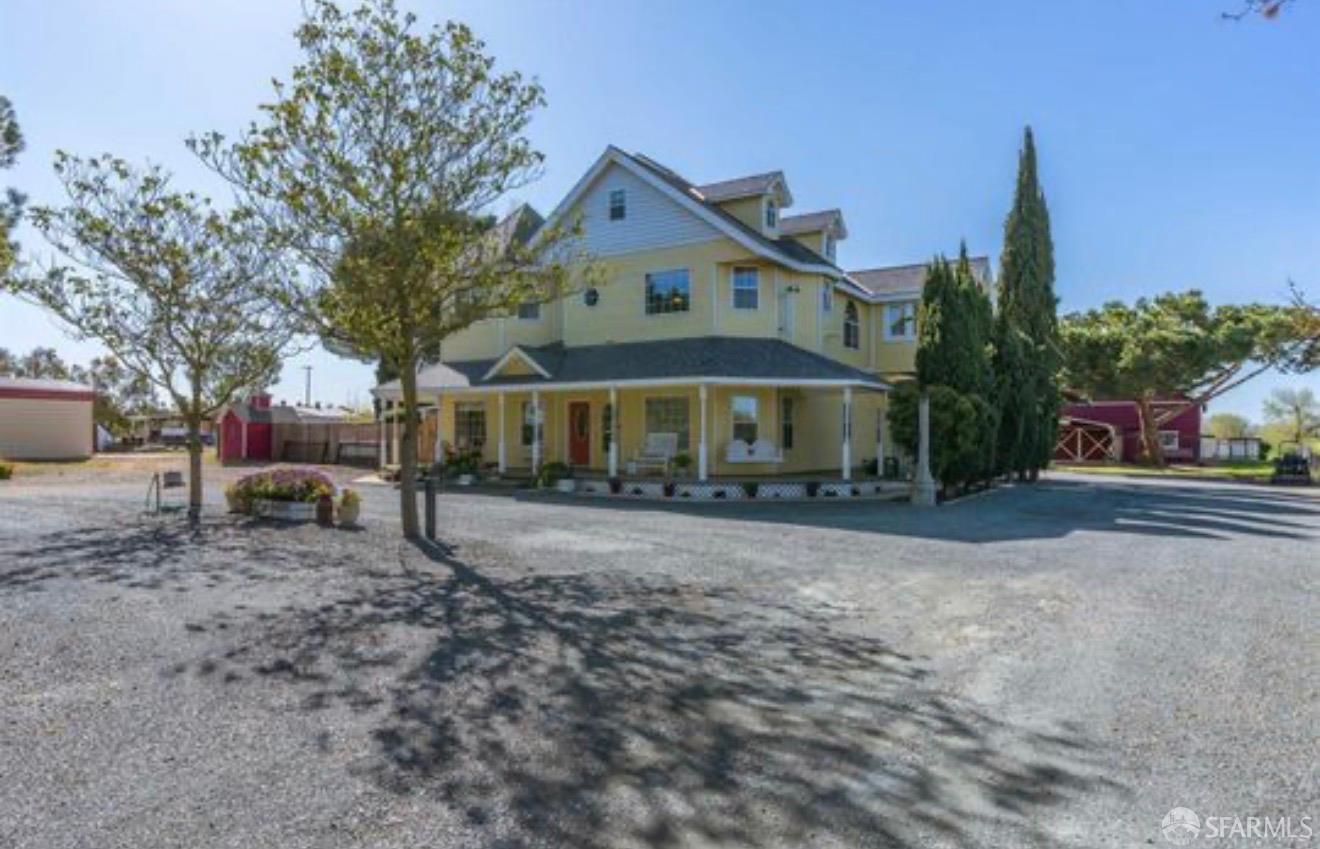 4100 Gateway Road Bethel Island, CA 94511 - Photo 9 of 53 a front view of a house with a yard and garage