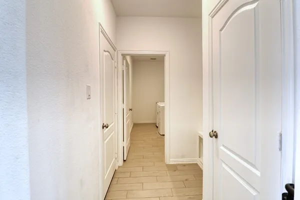a bathroom with a granite countertop tub sink and mirror