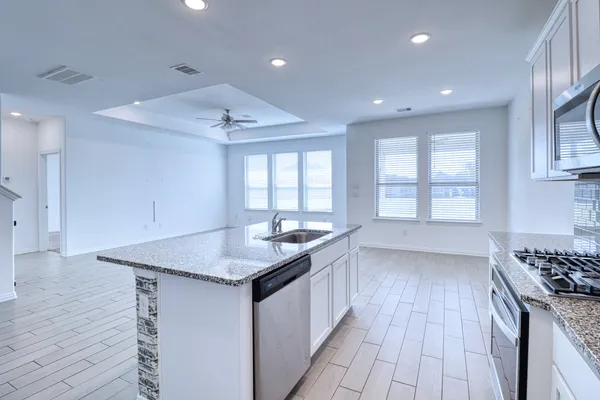 a view of a hallway with wooden floor and entryway