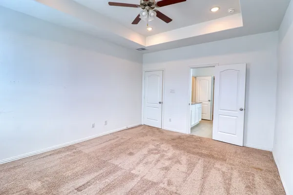 an empty room with a fan and a fan