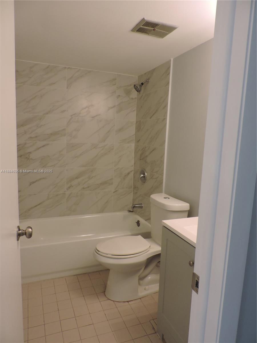 13045 Southwest 68th Street, Unit 104 Miami, FL 33183 - Photo 2 of 16 a bathroom with a toilet and a shower