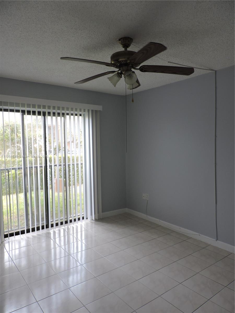 13045 Southwest 68th Street, Unit 104 Miami, FL 33183 - Photo 4 of 16 a view of an empty room with a window