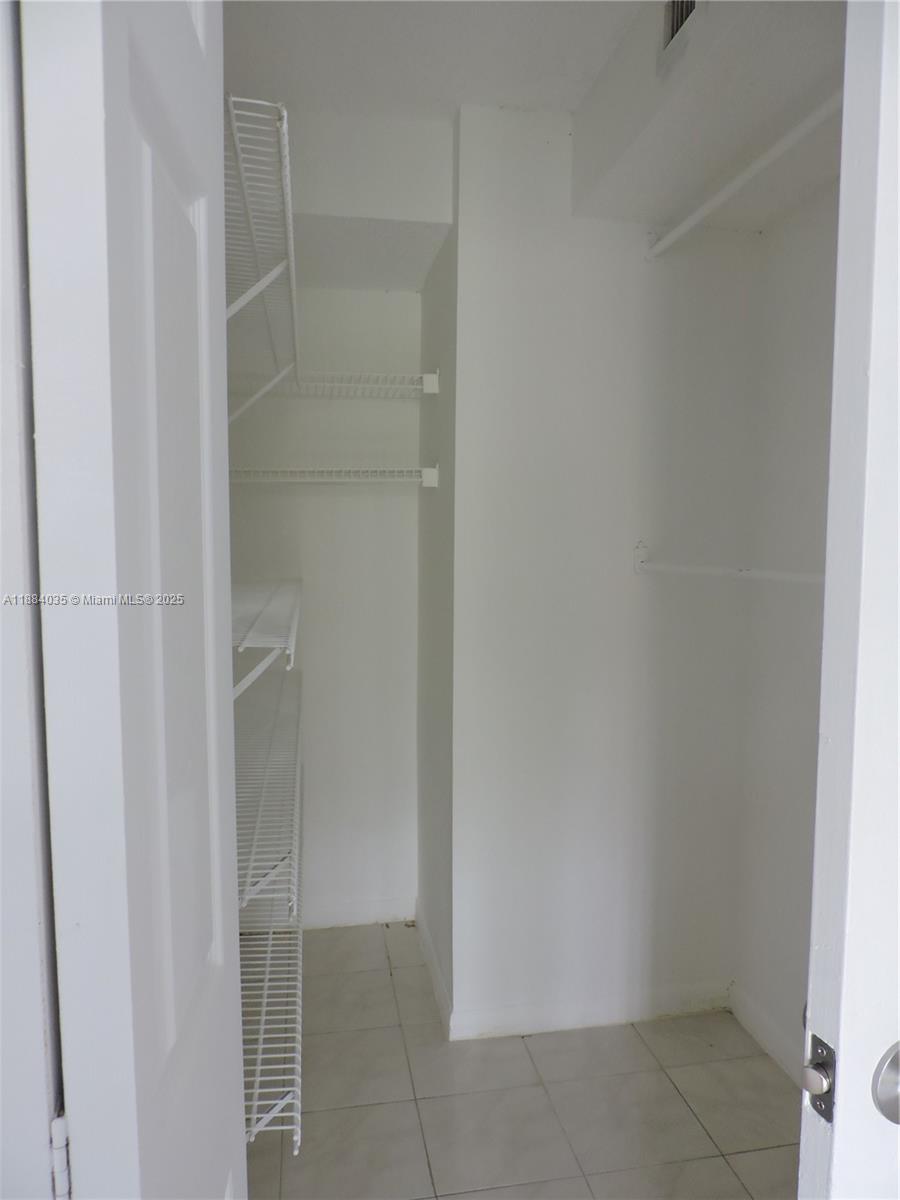 13045 Southwest 68th Street, Unit 104 Miami, FL 33183 - Photo 6 of 16 a view of an empty walk in closet