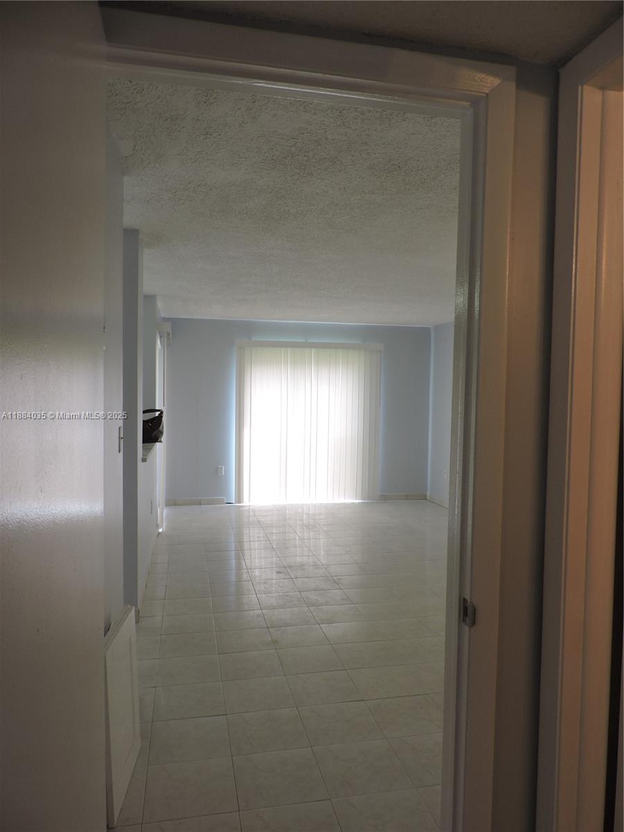 13045 Southwest 68th Street, Unit 104 Miami, FL 33183 - Photo 8 of 16 a view of empty room