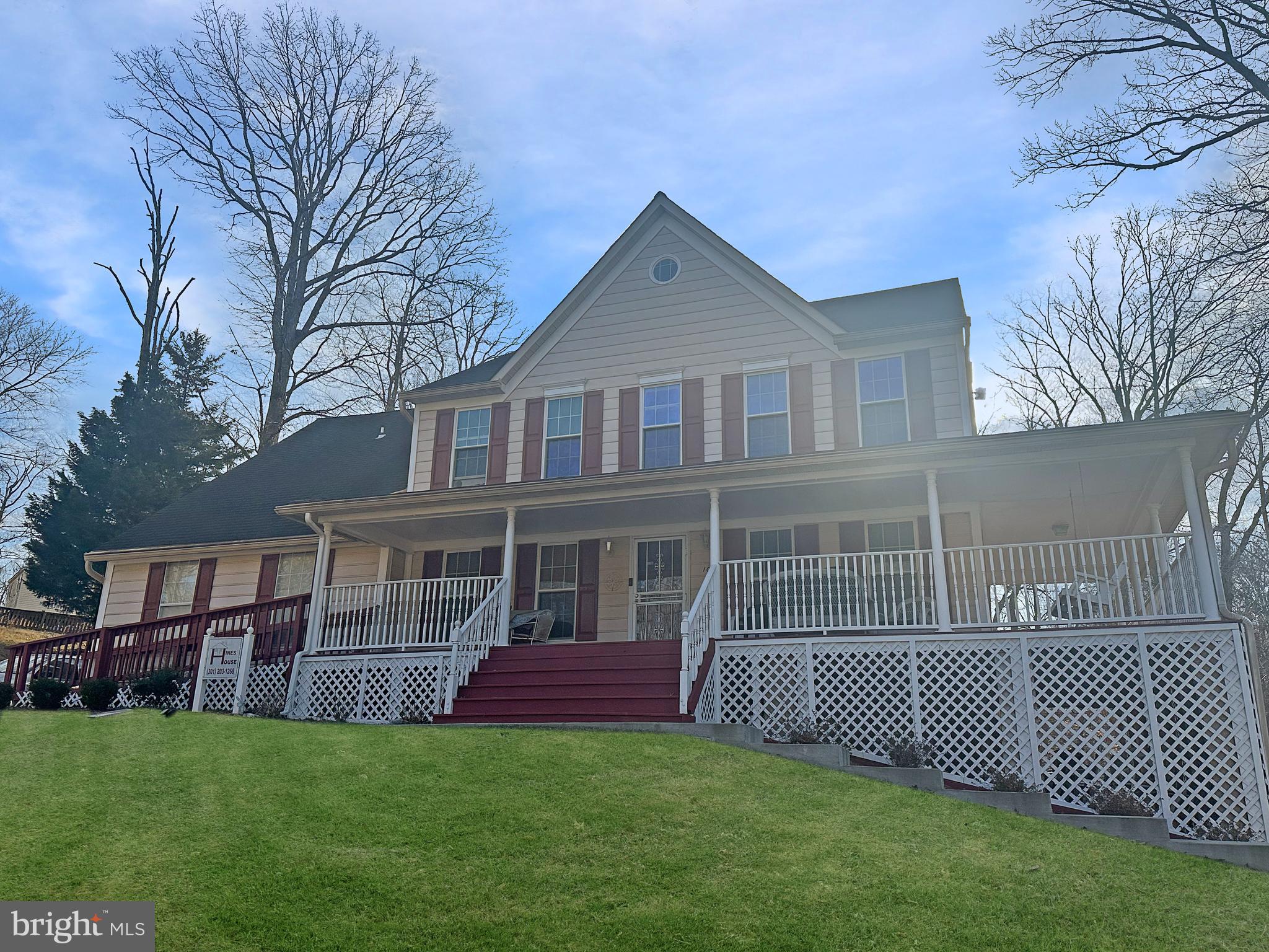 a front view of a house with a garden and deck