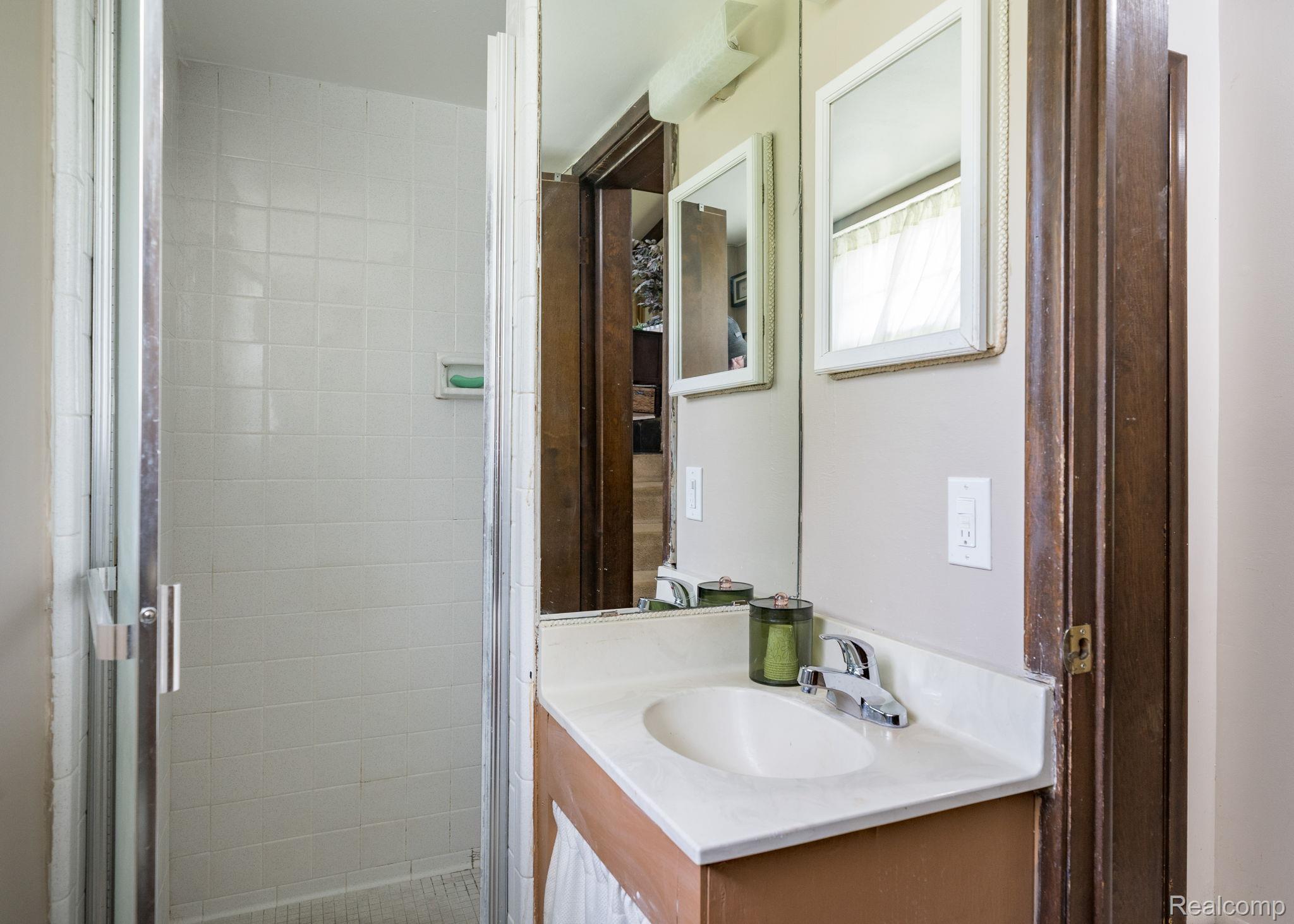 19650 Midway Road Southfield, MI 48075 - Photo 23 of 30 Bathroom featuring vanity and a shower stall