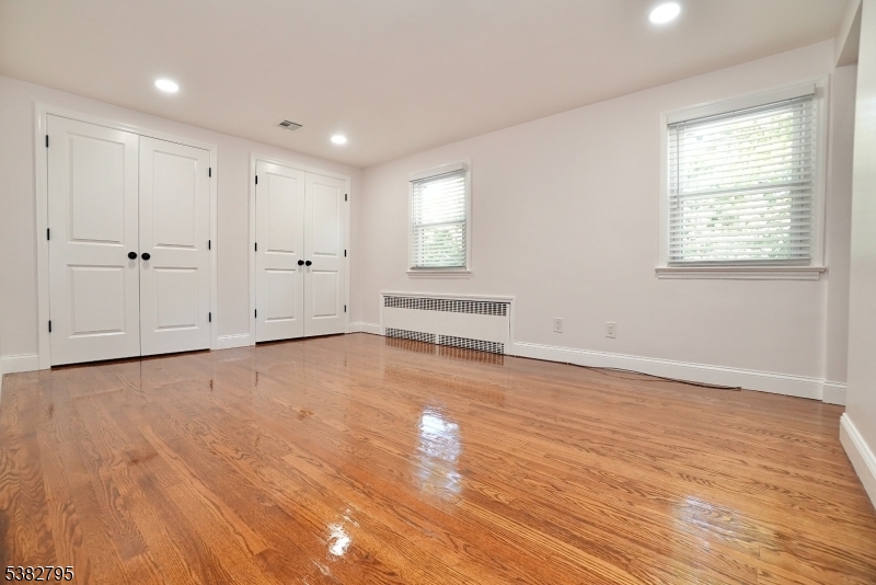 207 Franklin Avenue Belleville, NJ 07109 - Photo 9 of 9 a view of an empty room with wooden floor and a window