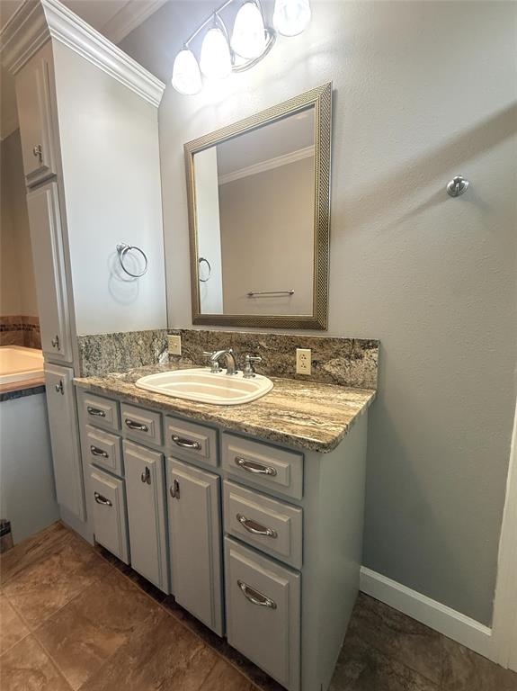 304 6th Street Northwest Springhill, LA 71075 - Photo 24 of 38 Vanity with an integrated sink, stone-finish countertop, and under-cabinet storage
