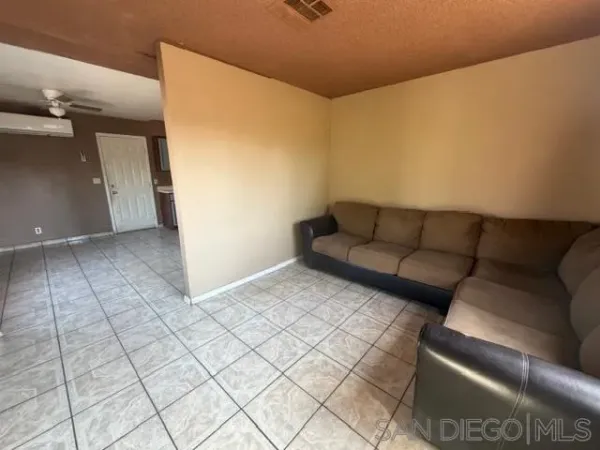 a living room with a couch and a walk in closet