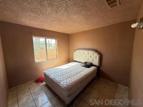 a bedroom with a bed and window