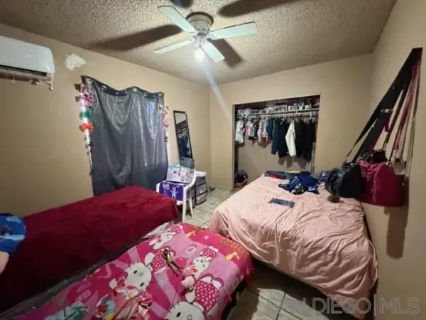 a bedroom with two beds and a chandelier