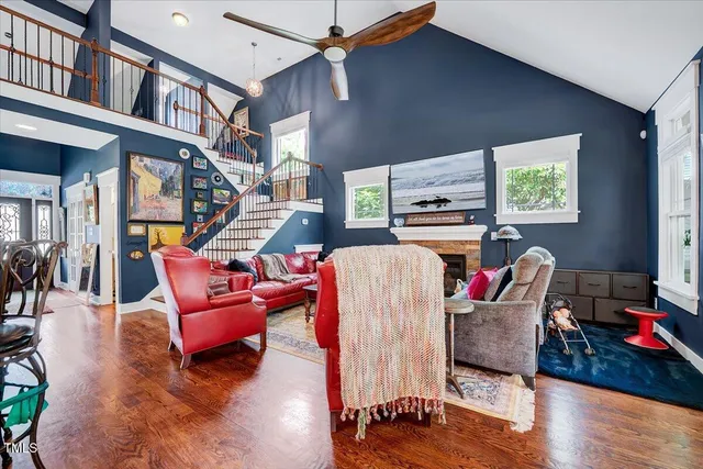 a living room with furniture fireplace and a window