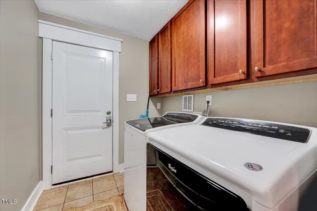 a view of a storage and utility room with washer and dryer
