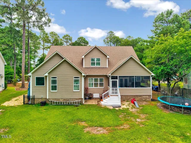 a view of a house with a yard and furniture