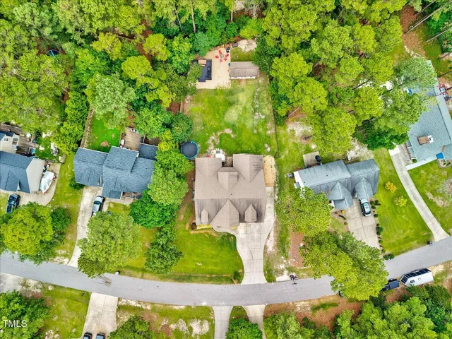 an aerial view of a house with a yard and garden