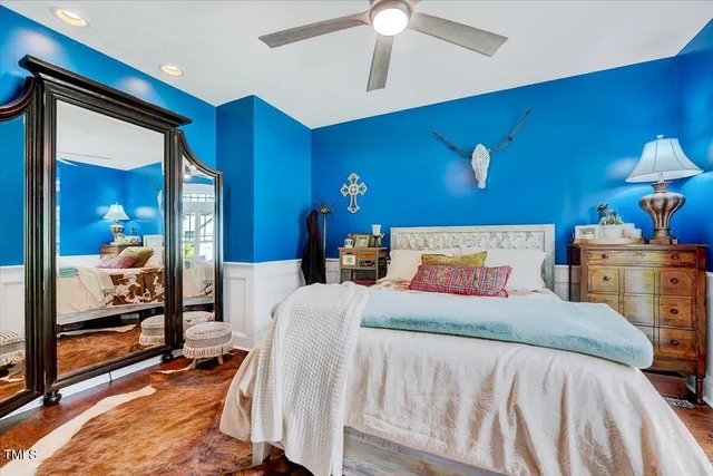 a bedroom with a bed and a chandelier