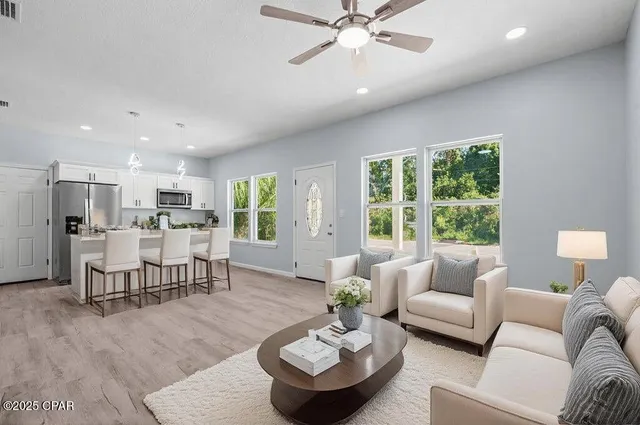 a living room with furniture and a large window