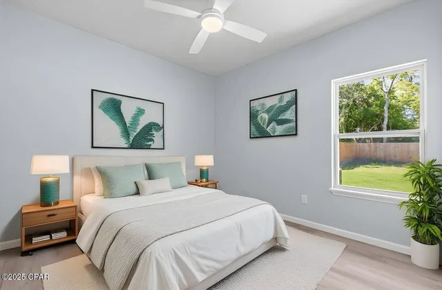 a bedroom with a bed and a painting on the wall