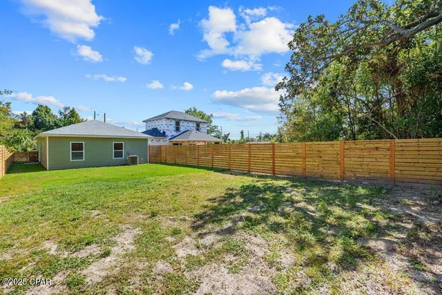 an aerial view of a residential houses with yard