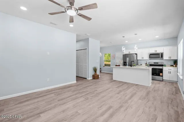 a view of kitchen with wooden floor and window