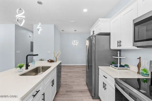 a kitchen with stainless steel appliances a sink stove and refrigerator