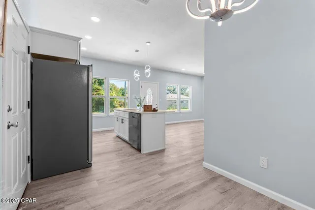a kitchen with stainless steel appliances a refrigerator and a stove top oven